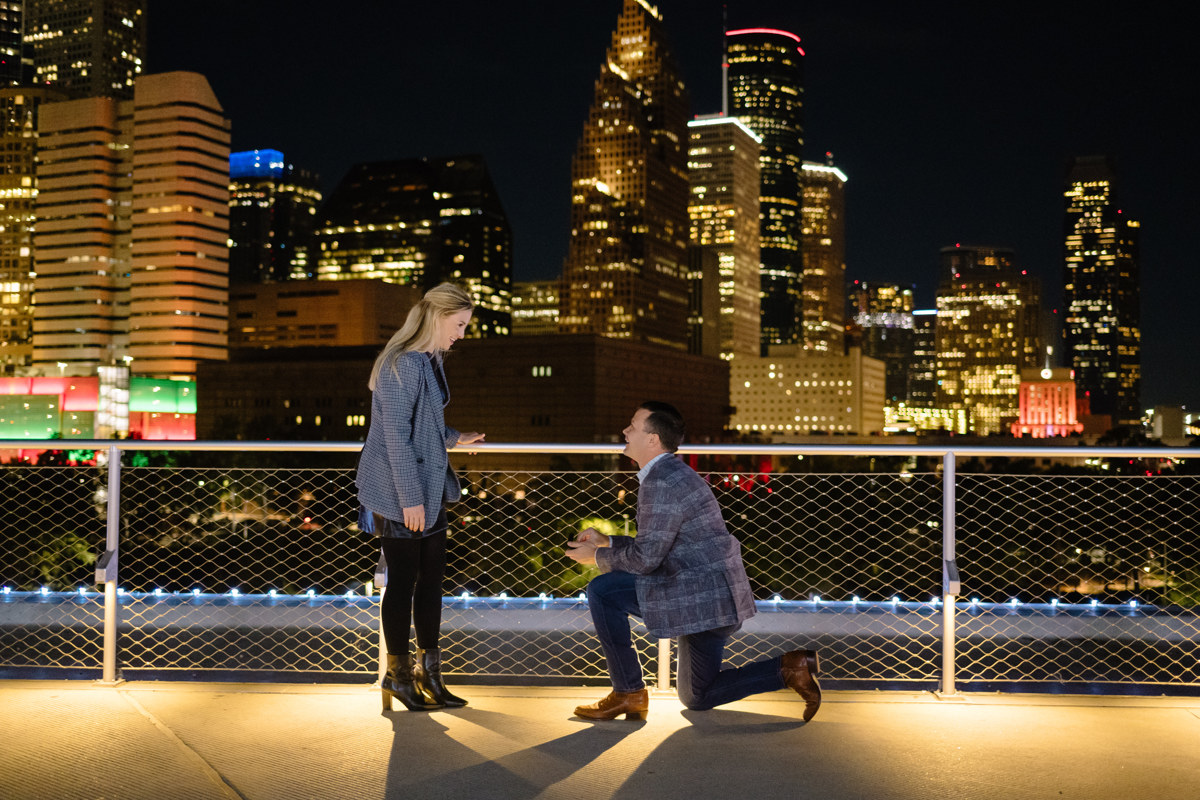 Post houston HTX garden rooftop proposal session during christmas with night houston skyline background
