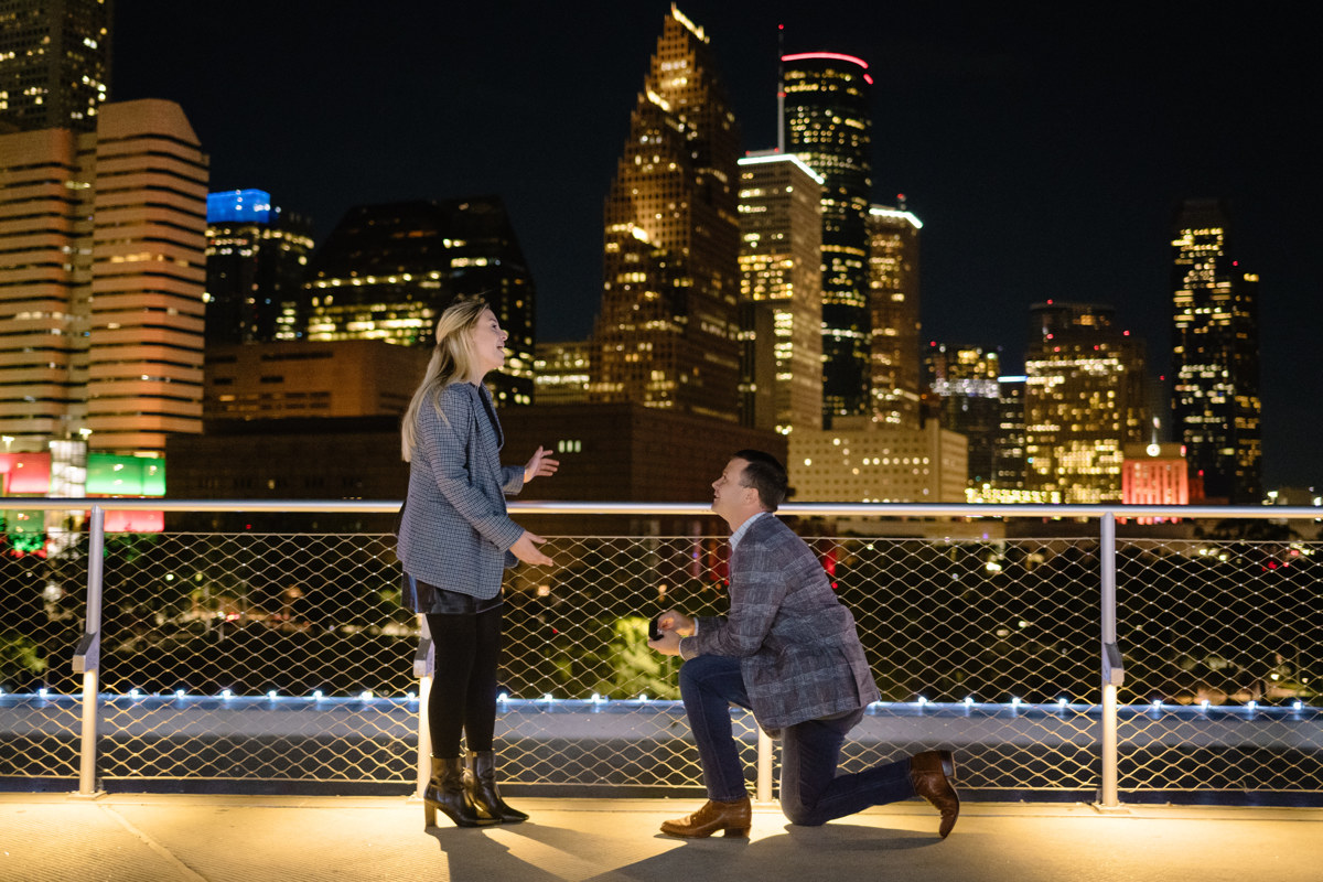 Post houston HTX garden rooftop proposal session during christmas with night houston skyline background