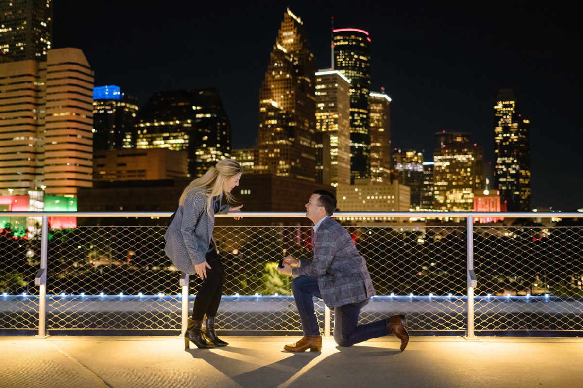 Post houston HTX garden rooftop proposal session during christmas with night houston skyline background