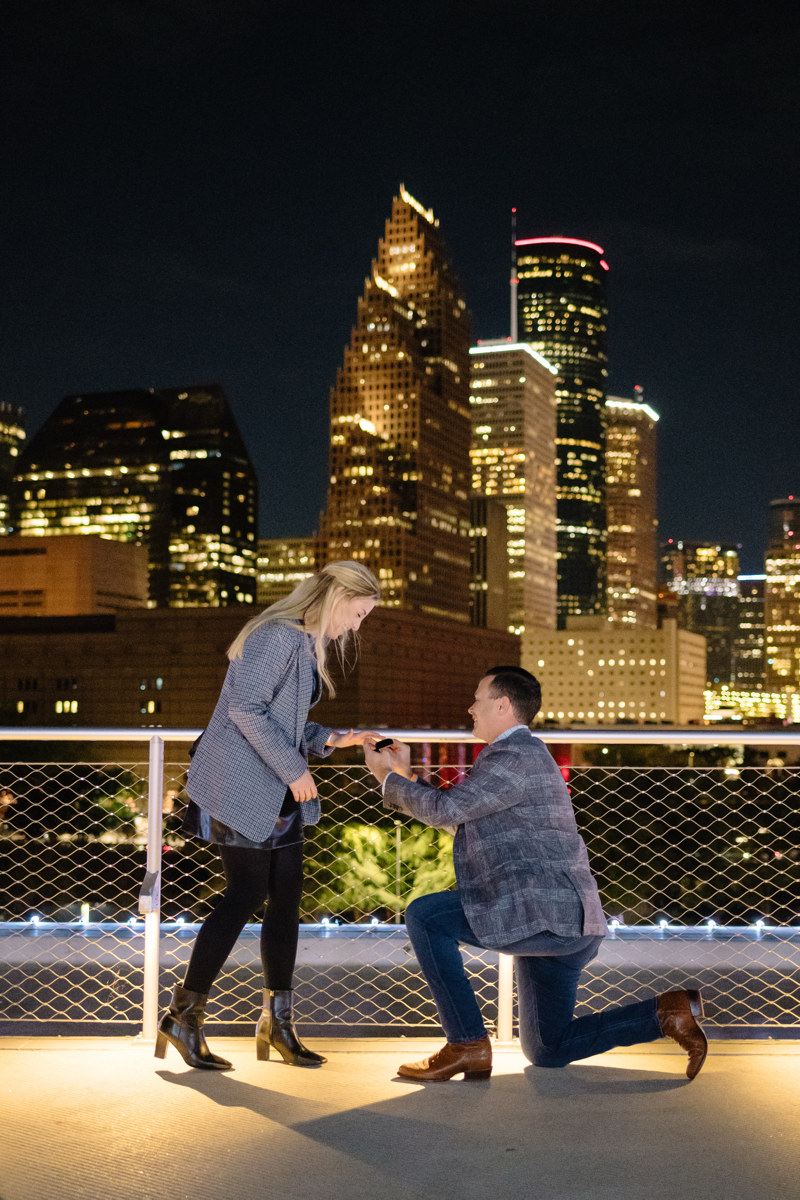 Post houston HTX garden rooftop proposal session during christmas with night houston skyline background