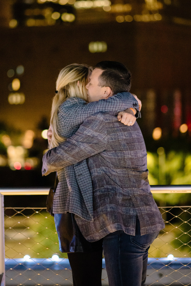 Post houston HTX garden rooftop proposal session during christmas with night houston skyline background