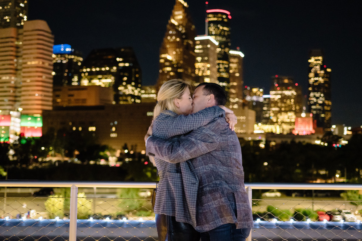 Post houston HTX garden rooftop proposal session during christmas with night houston skyline background