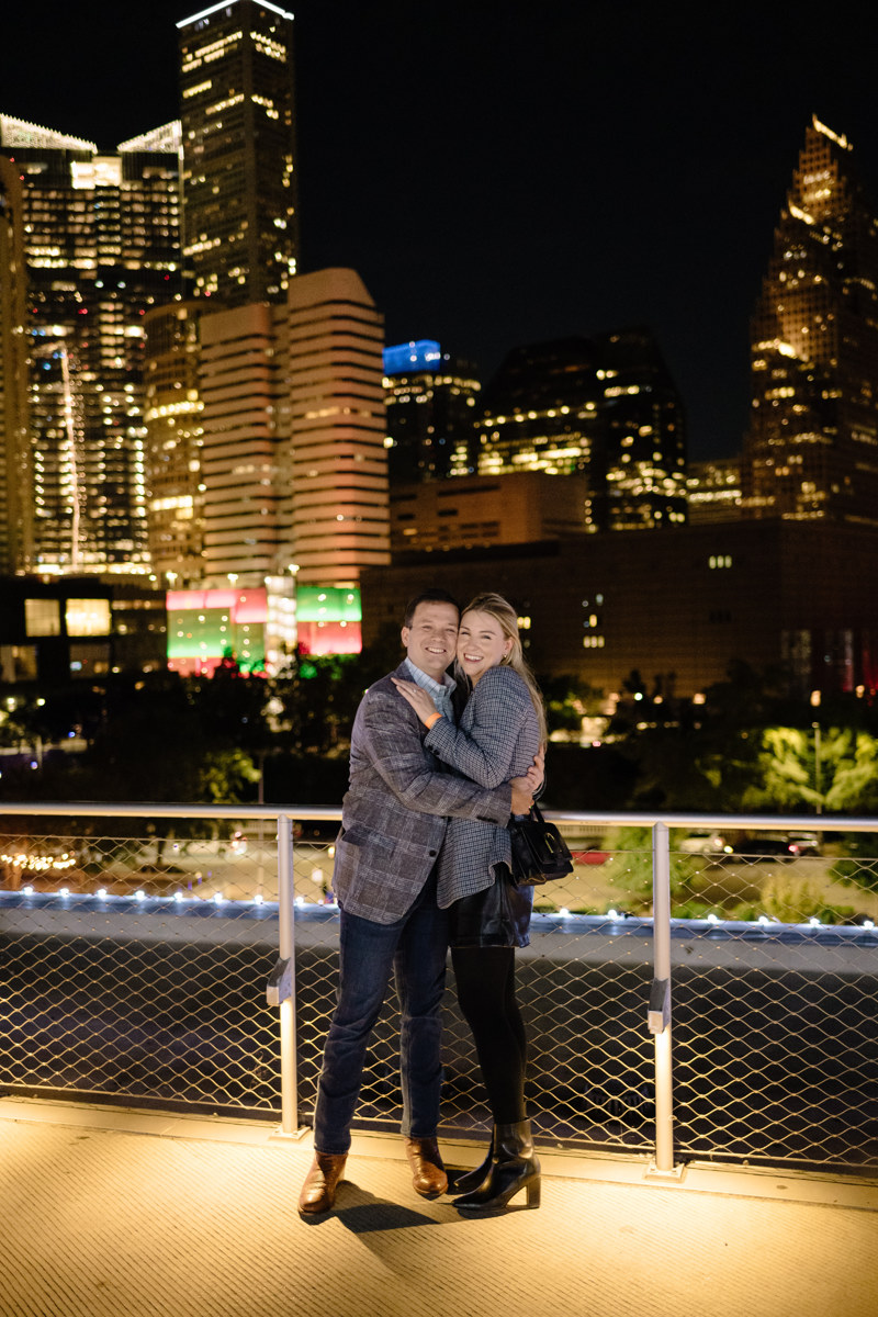 Post houston HTX garden rooftop proposal session during christmas with night houston skyline background