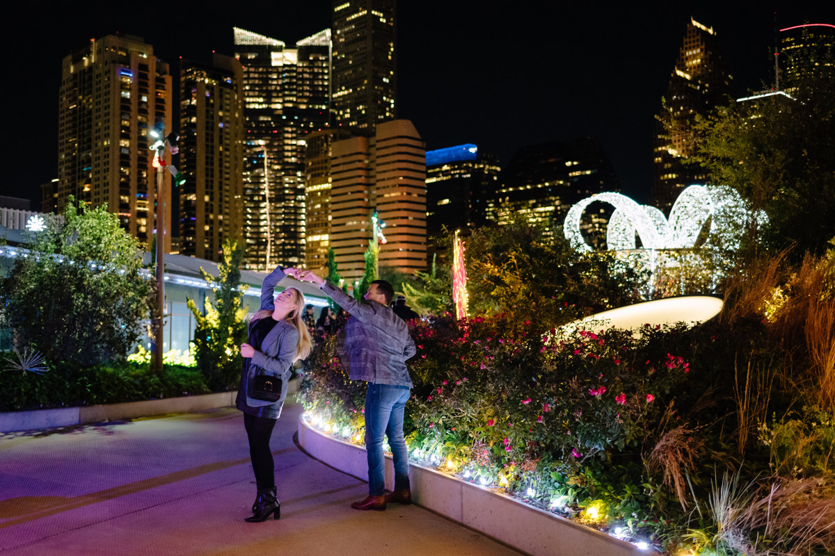 Post houston HTX garden rooftop proposal session during christmas with night houston skyline background
