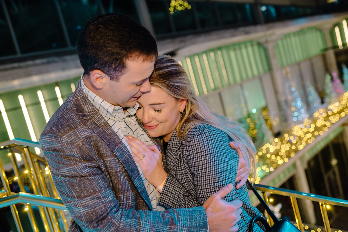 Post houston HTX garden rooftop proposal session during christmas with night houston skyline background